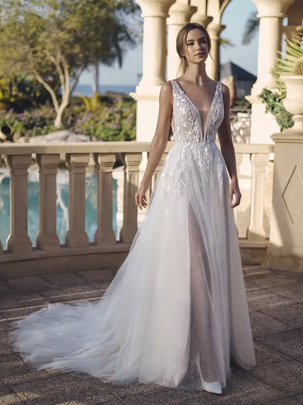 model is wearing an open back sleeveless lace bridal gown