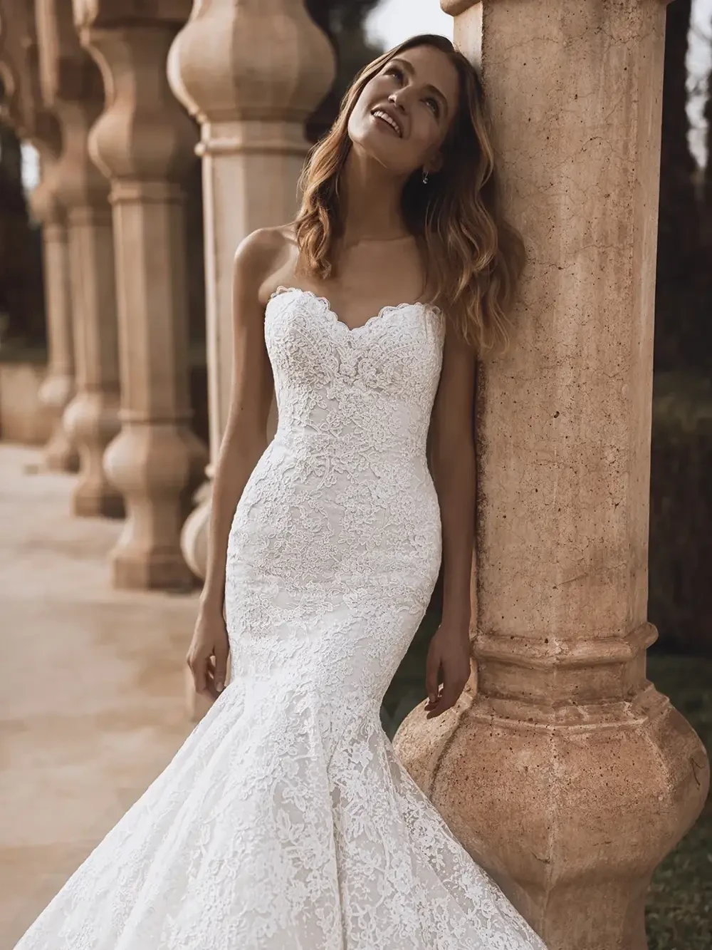 model is wearing a fitted strapless bridal gown